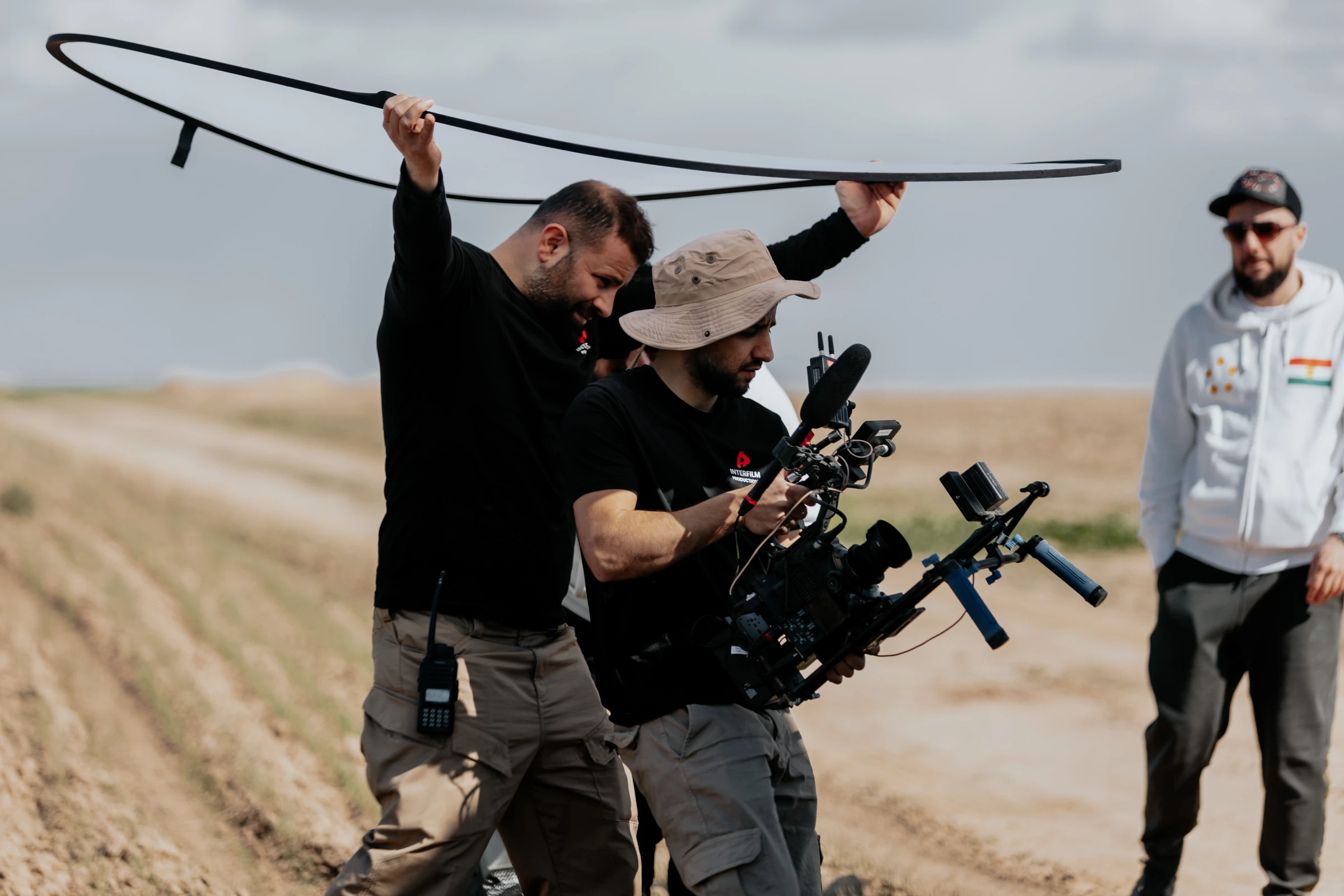 Interfilm crew filming on location with a bounce reflector