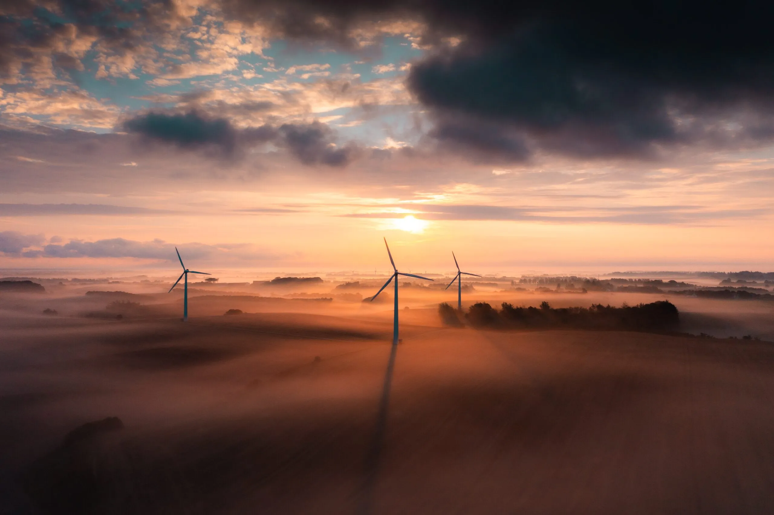 Aerial drone photography by Interfilm Productions — wind turbines at sunrise