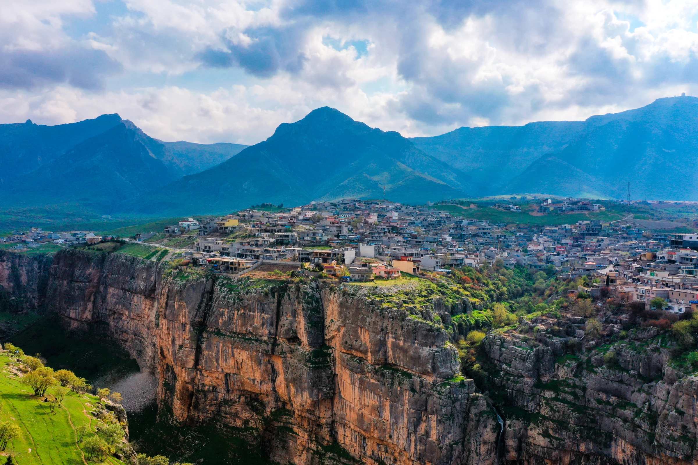 Aerial drone photography by Interfilm Productions — clifftop village in the Iraqi Kurdistan mountains